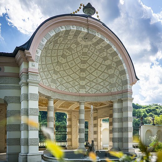 Muschelpavillon Hofgarten Eichstätt Auf dem Bild ist der mittlere und größte Pavillon des Hofgartens. Der Pavillon ist rund und nach vorne hin geöffnet. Ein Brunnen befindet sich im Zentrum. Dahinter stehen mehrere weiß, grau gemusterte Säulen. Die Kuppel ist innen mit einem mosaikartigen Muster aus grauen und weißen Elementen geschmückt. Das Dach wird von einer vasenähnlichen Figur geziert.
Bildbeschreibung ehemalige Kapuzinerkirche (innen)